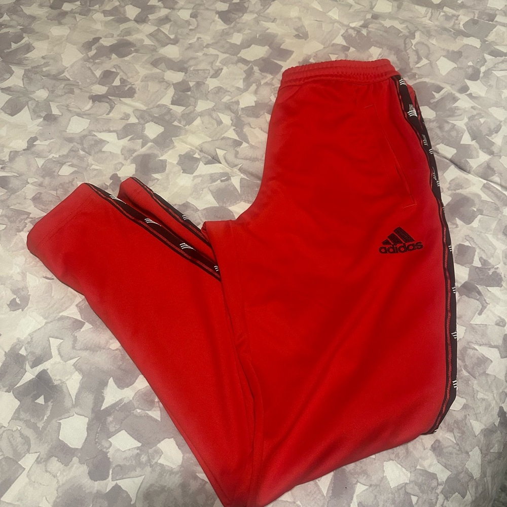 Red adidas track pants